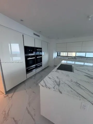 a view of a bathroom with a tub a sink a mirror and a shower