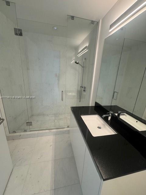 18555 Collins Avenue, Unit 2905 Sunny Isles Beach, FL 33160 - Photo 33 of 40 a bathroom with a tub sink and vanity