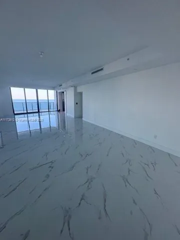 a kitchen with stainless steel appliances a sink a stove top oven a counter space and cabinets