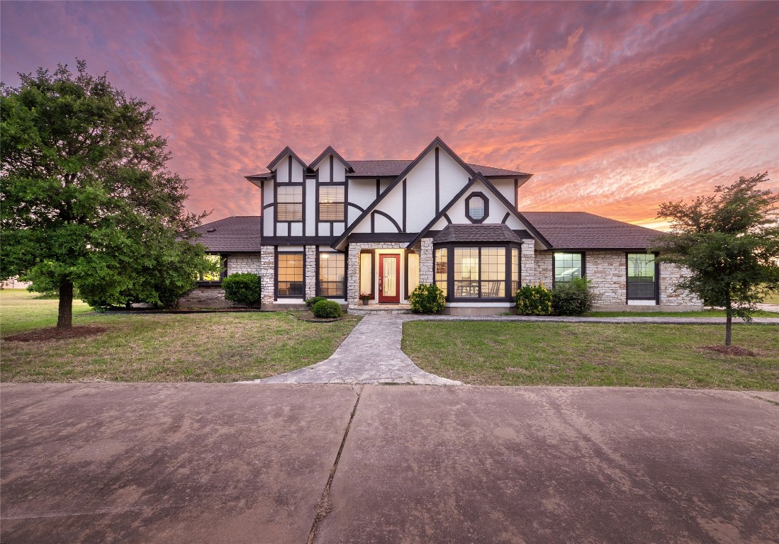 a front view of house with yard and green space