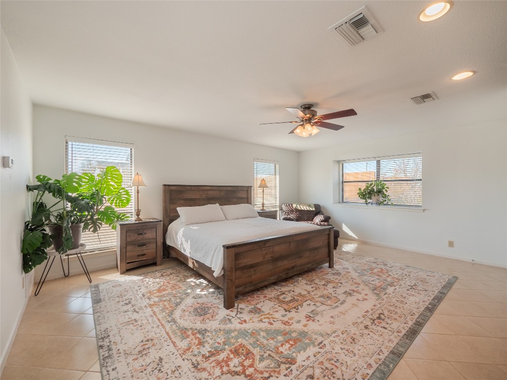 1822 Rowe Loop Pflugerville, TX 78660 - Photo 15 of 40 a spacious bedroom with a bed and a potted plant
