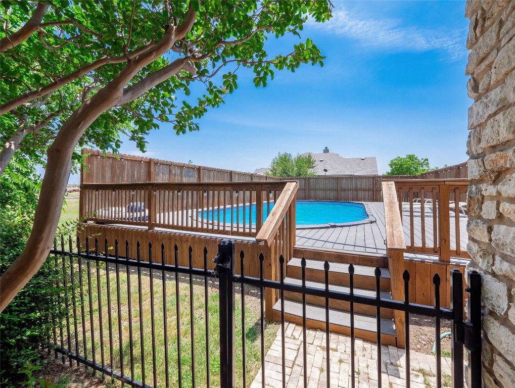 1822 Rowe Loop Pflugerville, TX 78660 - Photo 30 of 40 a view of balcony with wooden floor and fence