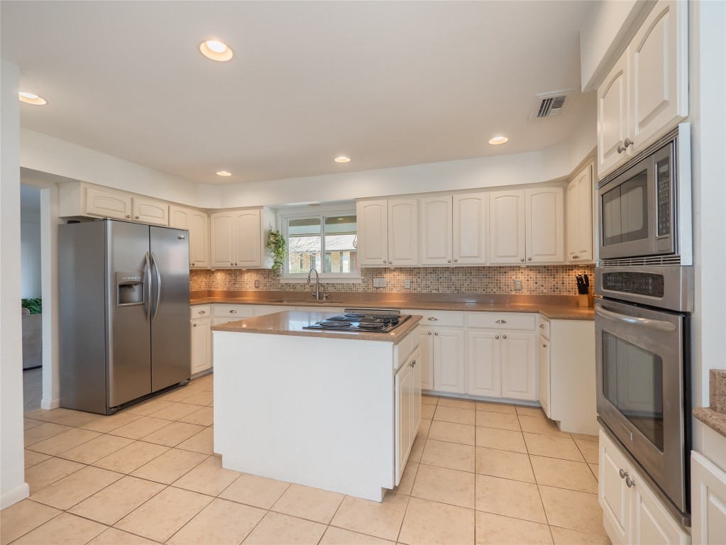 1822 Rowe Loop Pflugerville, TX 78660 - Photo 7 of 40 a kitchen with stainless steel appliances granite countertop a refrigerator and a stove top oven