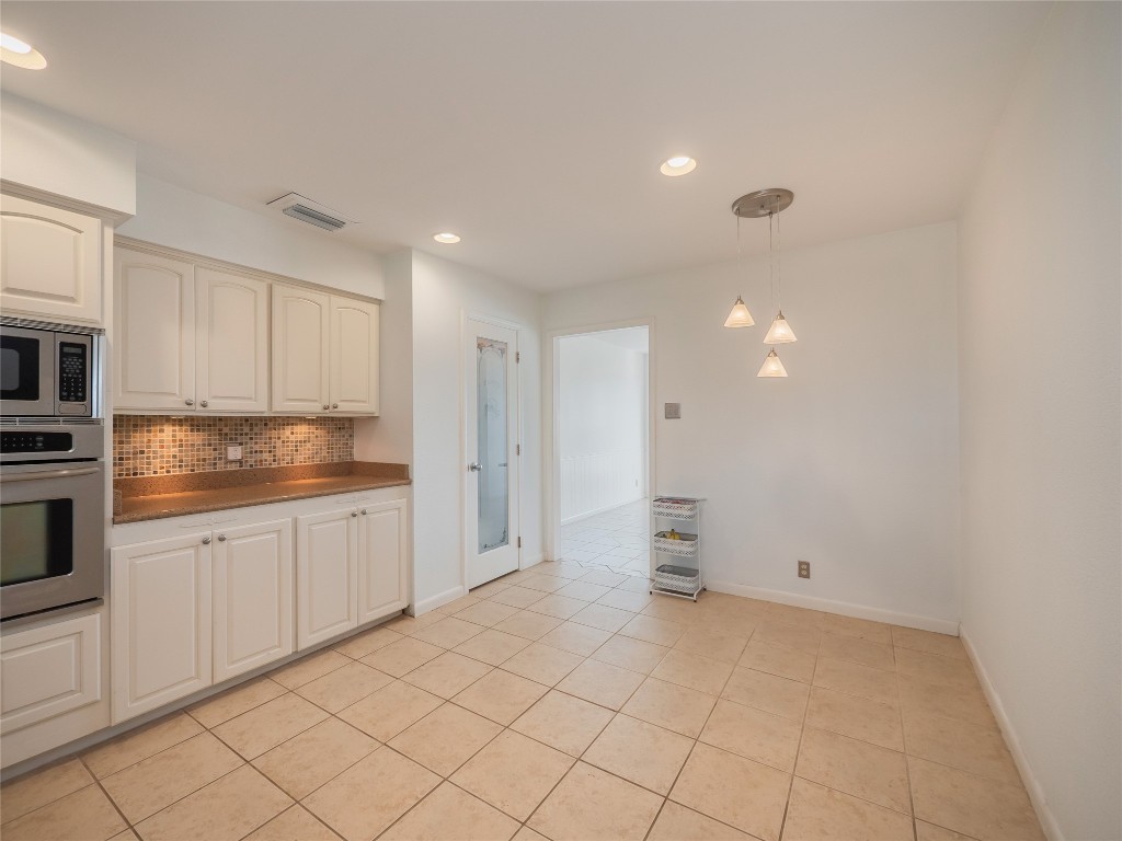 1822 Rowe Loop Pflugerville, TX 78660 - Photo 10 of 40 a view of a kitchen with white cabinets