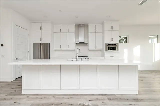 a kitchen with stainless steel appliances white cabinets and a sink