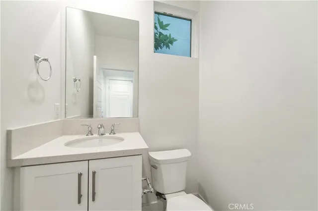 a bathroom with a sink toilet and vanity
