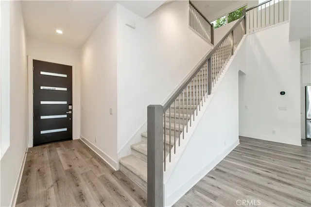 a view of a hallway with wooden floor and entryway