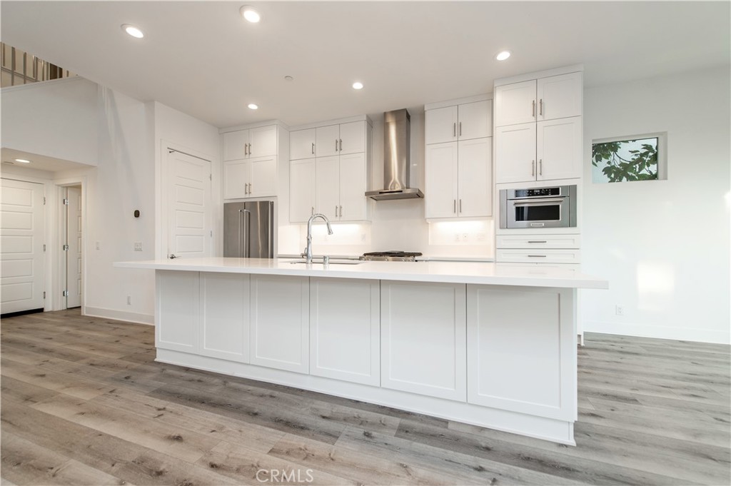 26380 Paseo Sillin San Juan Capistrano, CA 92675 - Photo 19 of 49 a large white kitchen with kitchen island a sink stainless steel appliances and cabinets