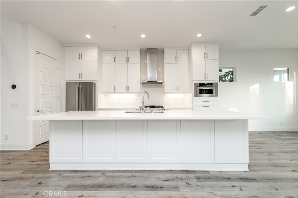 26380 Paseo Sillin San Juan Capistrano, CA 92675 - Photo 20 of 49 a kitchen with wooden cabinets stainless steel appliances and sink