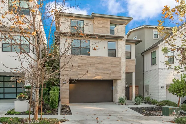 a front view of a house with plants