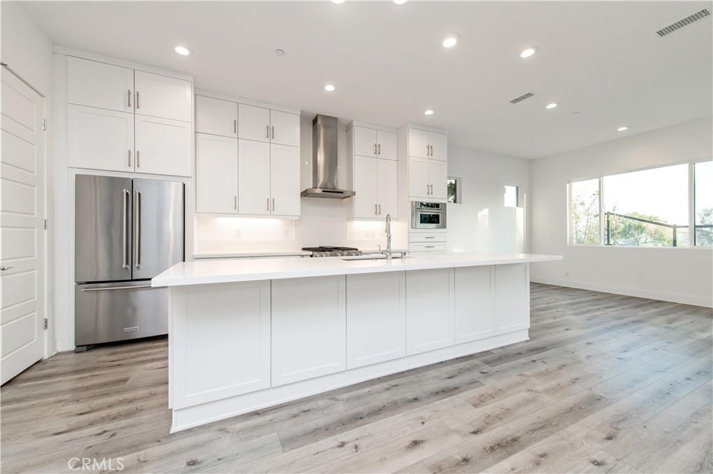 26380 Paseo Sillin San Juan Capistrano, CA 92675 - Photo 21 of 49 a kitchen with kitchen island white cabinets and refrigerator