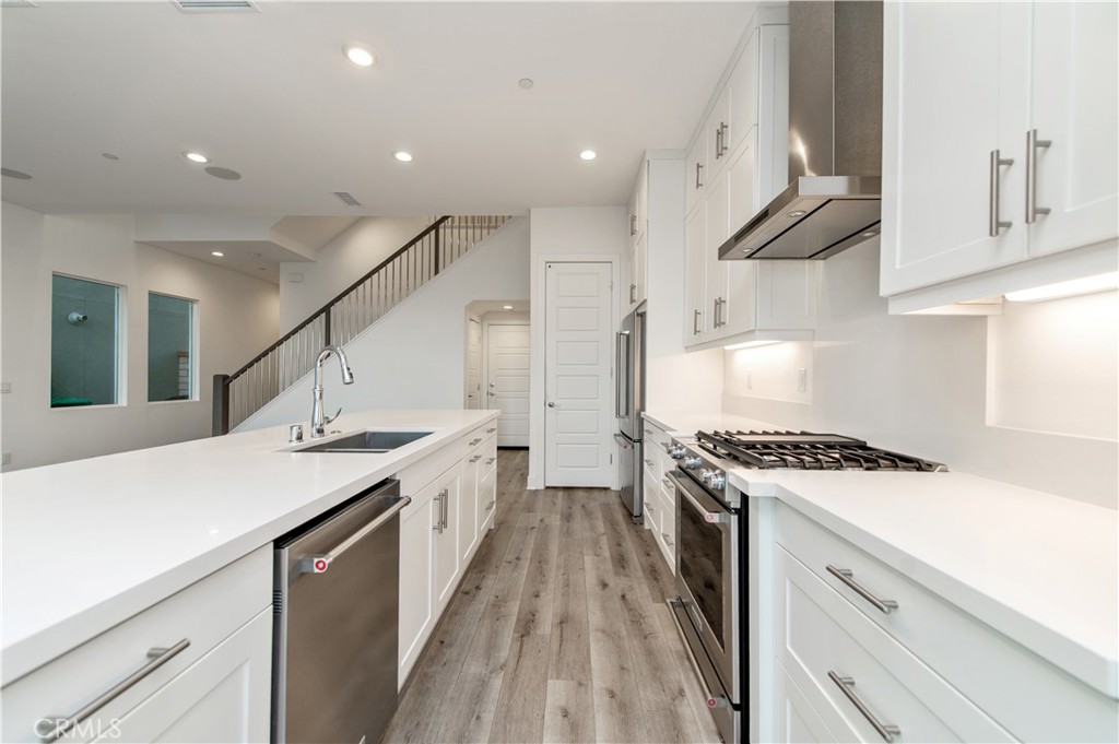 26380 Paseo Sillin San Juan Capistrano, CA 92675 - Photo 22 of 49 a kitchen with a stove a sink and a refrigerator