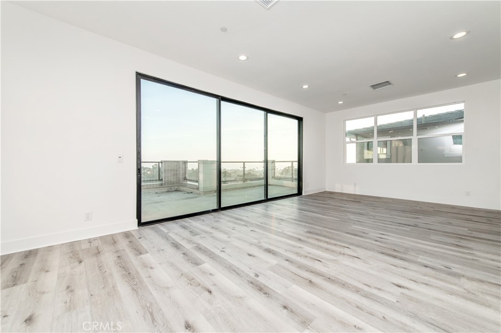 26380 Paseo Sillin San Juan Capistrano, CA 92675 - Photo 39 of 49 an empty room with wooden floor and windows