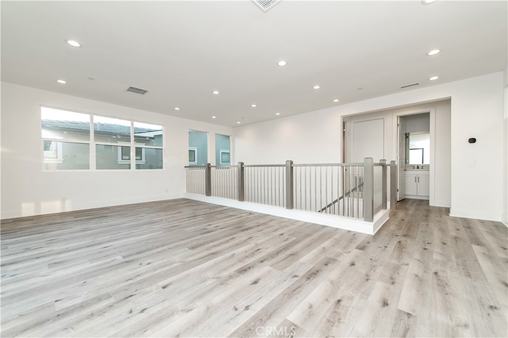 26380 Paseo Sillin San Juan Capistrano, CA 92675 - Photo 40 of 49 a view of an empty room with wooden floor and a window