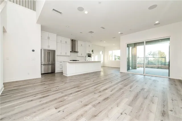 a view of kitchen with wooden floor and electronic appliances