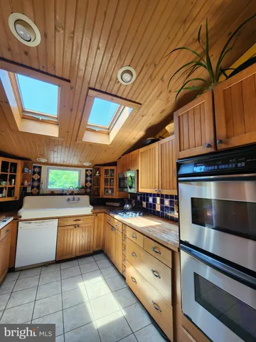 a kitchen with stainless steel appliances granite countertop a stove and a sink