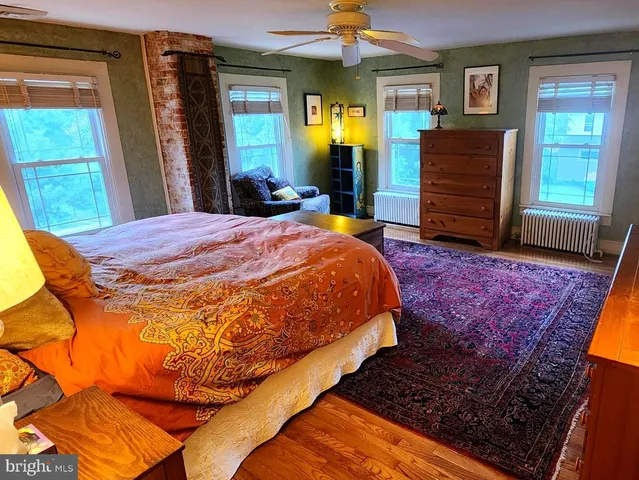 a bed sitting in a bedroom next to a window