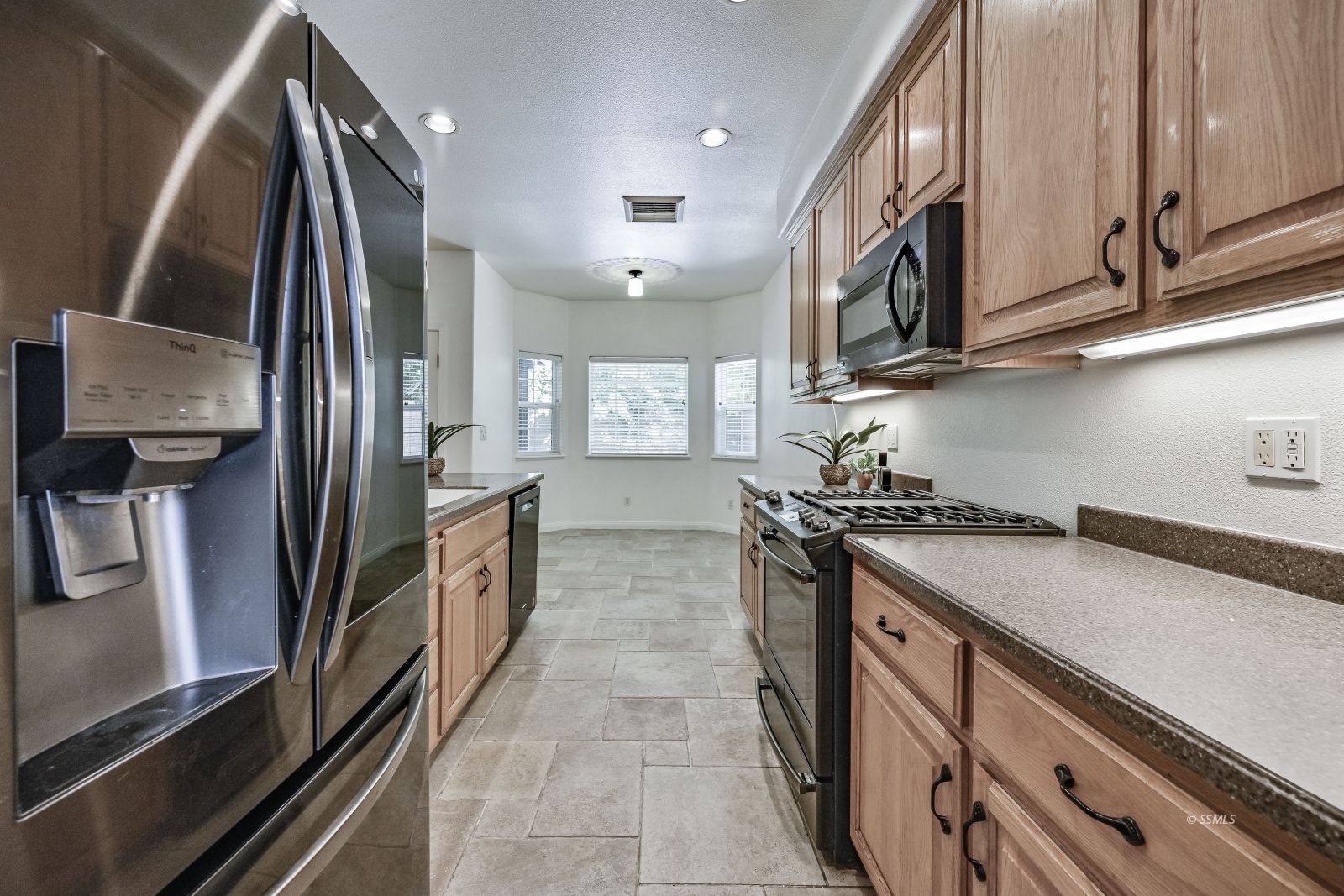 425 Acacia Street Ridgecrest, CA 93555 - Photo 4 of 49 a kitchen with stainless steel appliances granite countertop a sink and stove