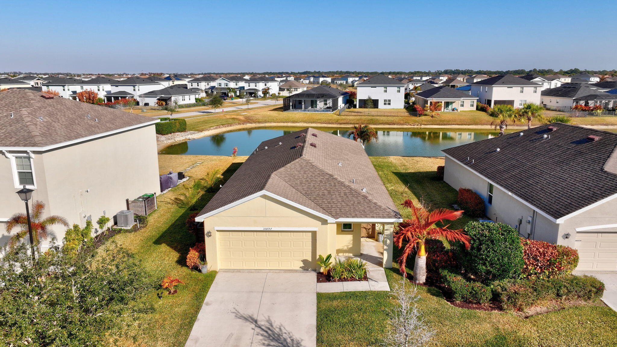 10897 Pacini Way Port St. Lucie, FL 34987 - Photo 1 of 35 a view of a swimming pool with an outdoor seating and mountain view