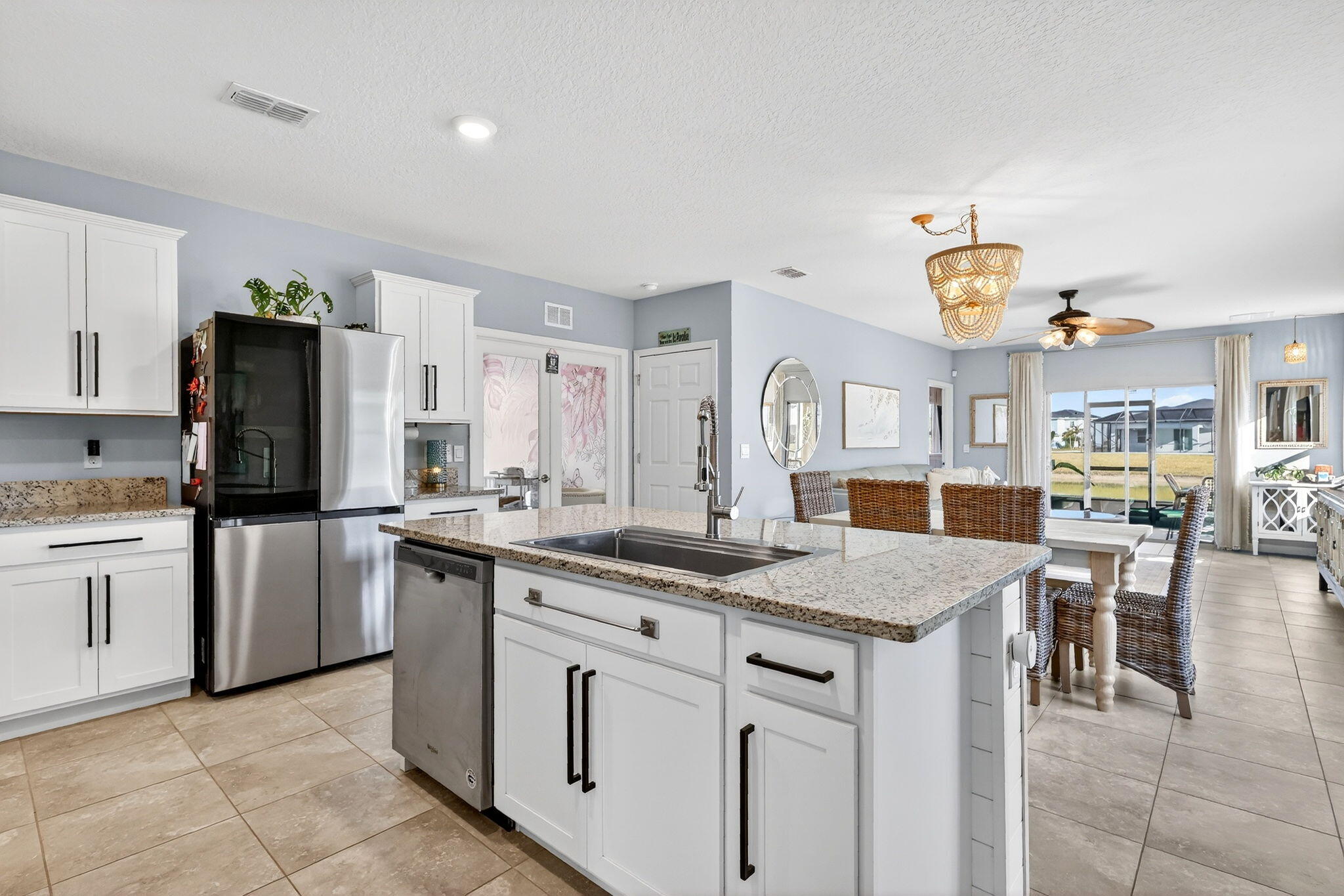10897 Pacini Way Port St. Lucie, FL 34987 - Photo 2 of 35 a kitchen with stainless steel appliances granite countertop a sink and a refrigerator