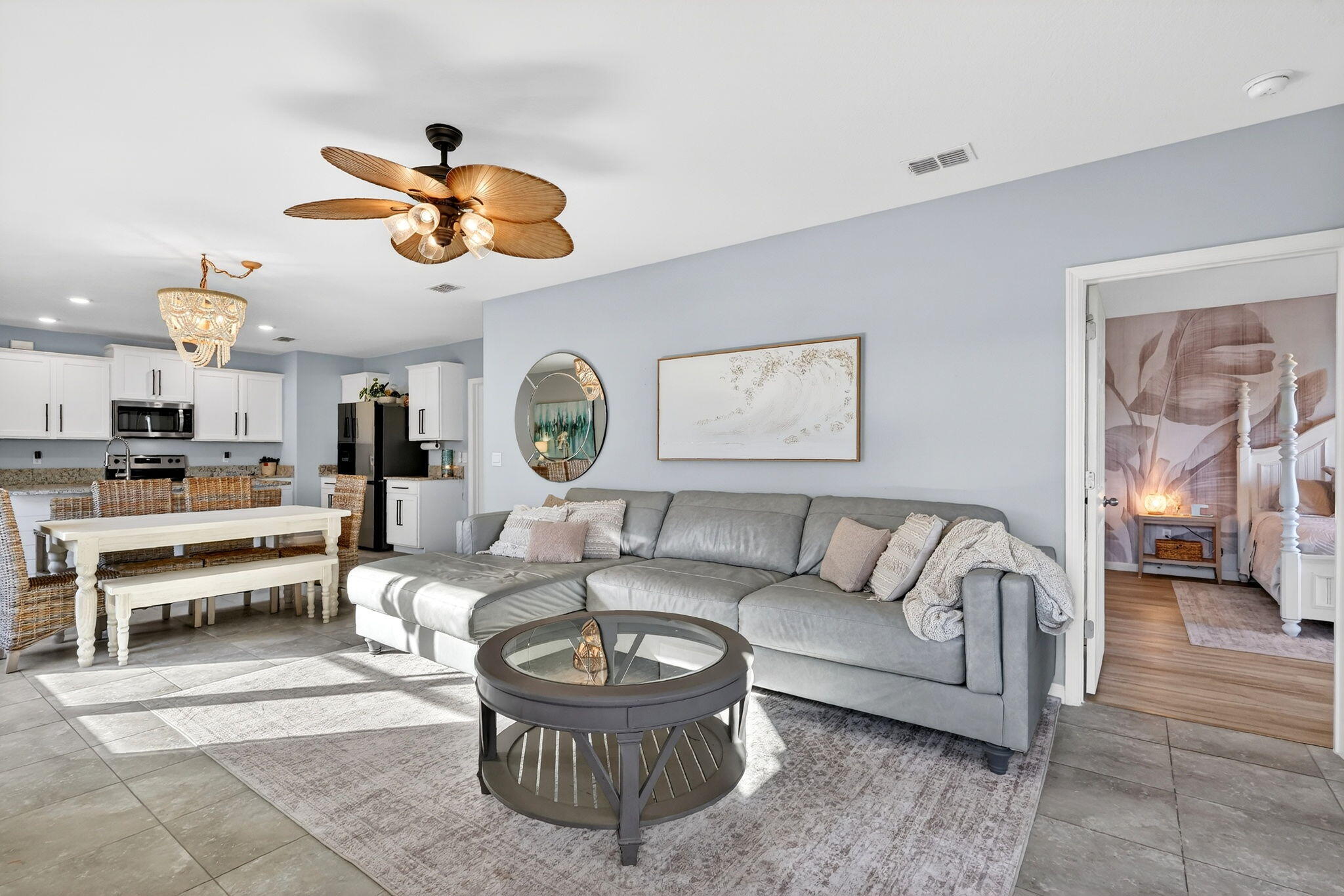 10897 Pacini Way Port St. Lucie, FL 34987 - Photo 10 of 35 a living room with furniture a rug and a chandelier