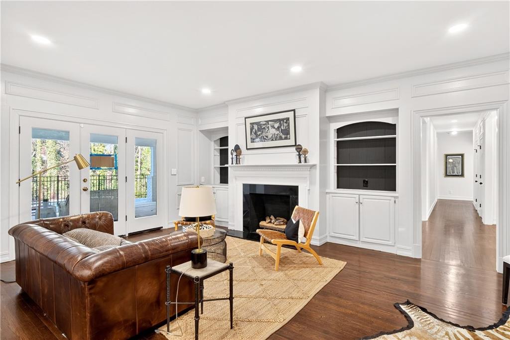 1330 West Wesley Road Northwest Atlanta, GA 30327 - Photo 12 of 46 a living room with furniture a fireplace and a floor to ceiling window