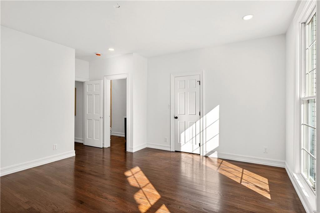 1330 West Wesley Road Northwest Atlanta, GA 30327 - Photo 21 of 46 an empty room with wooden floor and windows