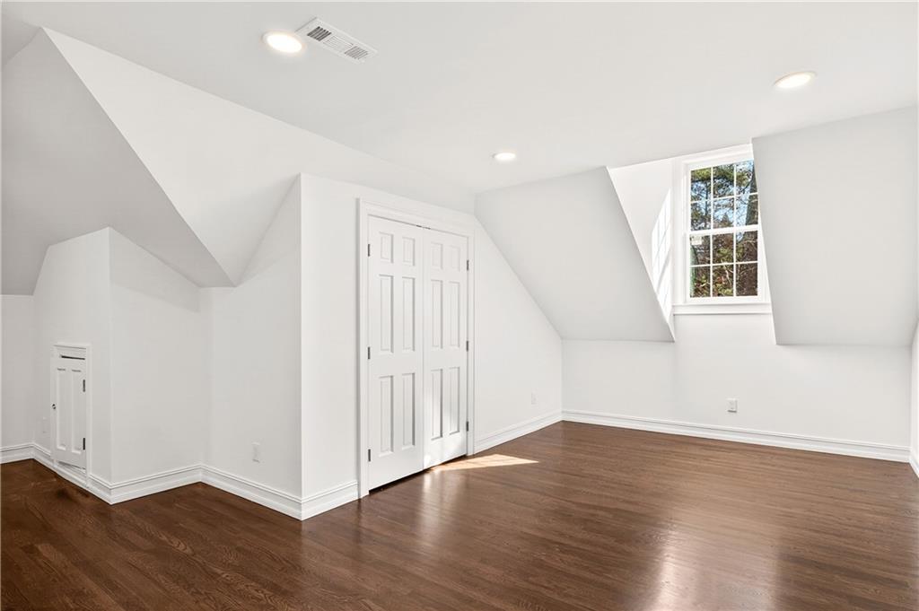 1330 West Wesley Road Northwest Atlanta, GA 30327 - Photo 23 of 46 an empty room with wooden floor and windows
