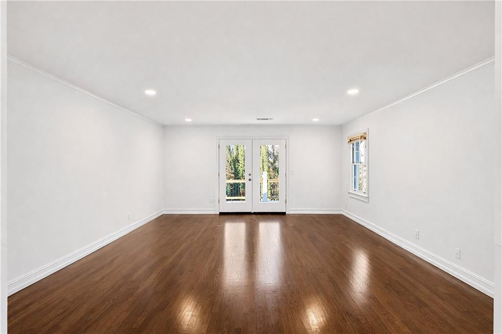 1330 West Wesley Road Northwest Atlanta, GA 30327 - Photo 28 of 46 a view of an empty room with wooden floor and a window