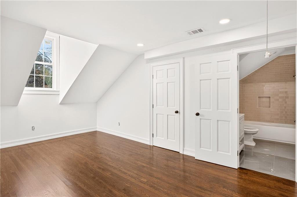 1330 West Wesley Road Northwest Atlanta, GA 30327 - Photo 29 of 46 wooden floor in an empty room with a window