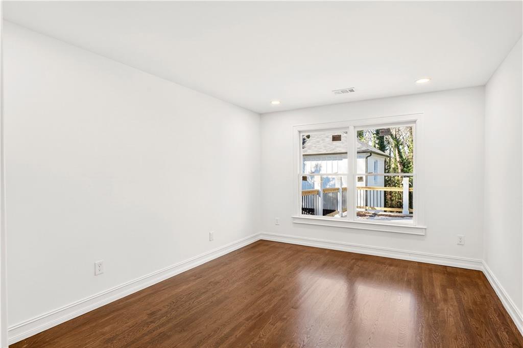 1330 West Wesley Road Northwest Atlanta, GA 30327 - Photo 30 of 46 an empty room with wooden floor and windows