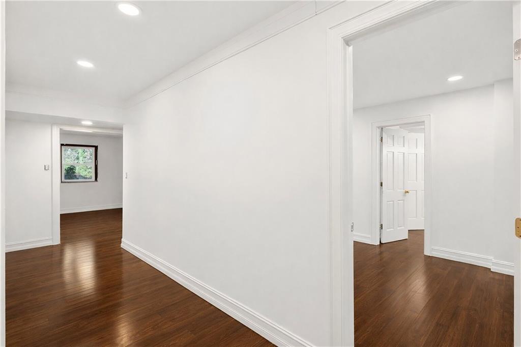 1330 West Wesley Road Northwest Atlanta, GA 30327 - Photo 32 of 46 an empty room with wooden floor and windows