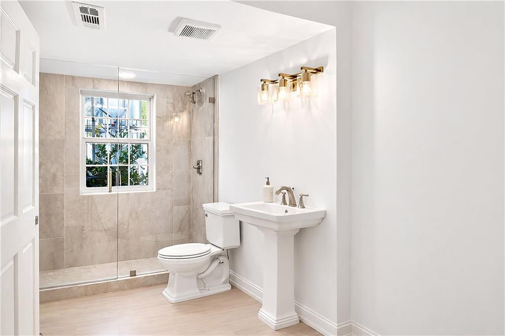 1330 West Wesley Road Northwest Atlanta, GA 30327 - Photo 33 of 46 a bathroom with a toilet sink and mirror