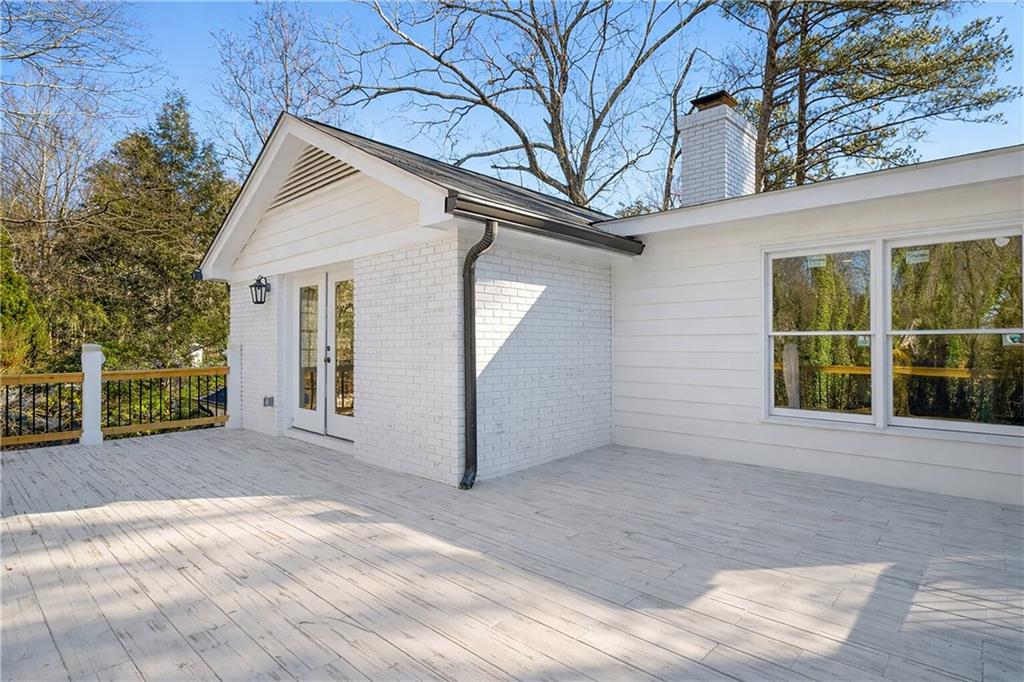 1330 West Wesley Road Northwest Atlanta, GA 30327 - Photo 35 of 46 a view of a house with a yard and garage