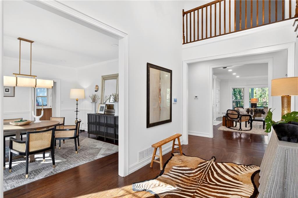 1330 West Wesley Road Northwest Atlanta, GA 30327 - Photo 4 of 46 a living room with furniture a wooden floor and a chandelier