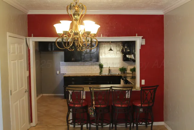 a kitchen with a dining table and chairs