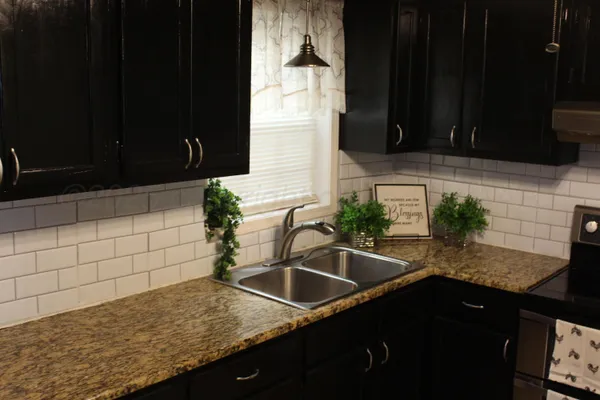 a kitchen with granite countertop a sink and a granite counter tops