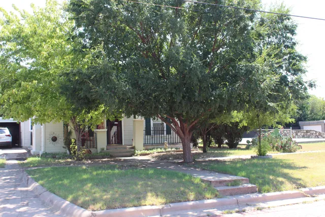 a view of a house with yard and tree s