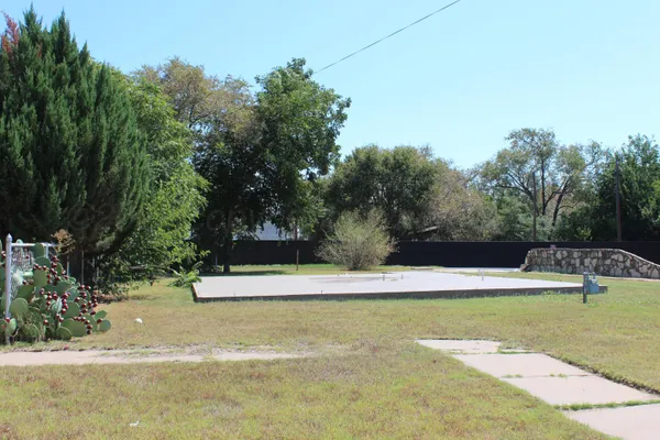 a view of a swimming pool with a yard