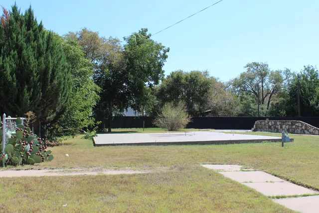 a view of a swimming pool with a yard