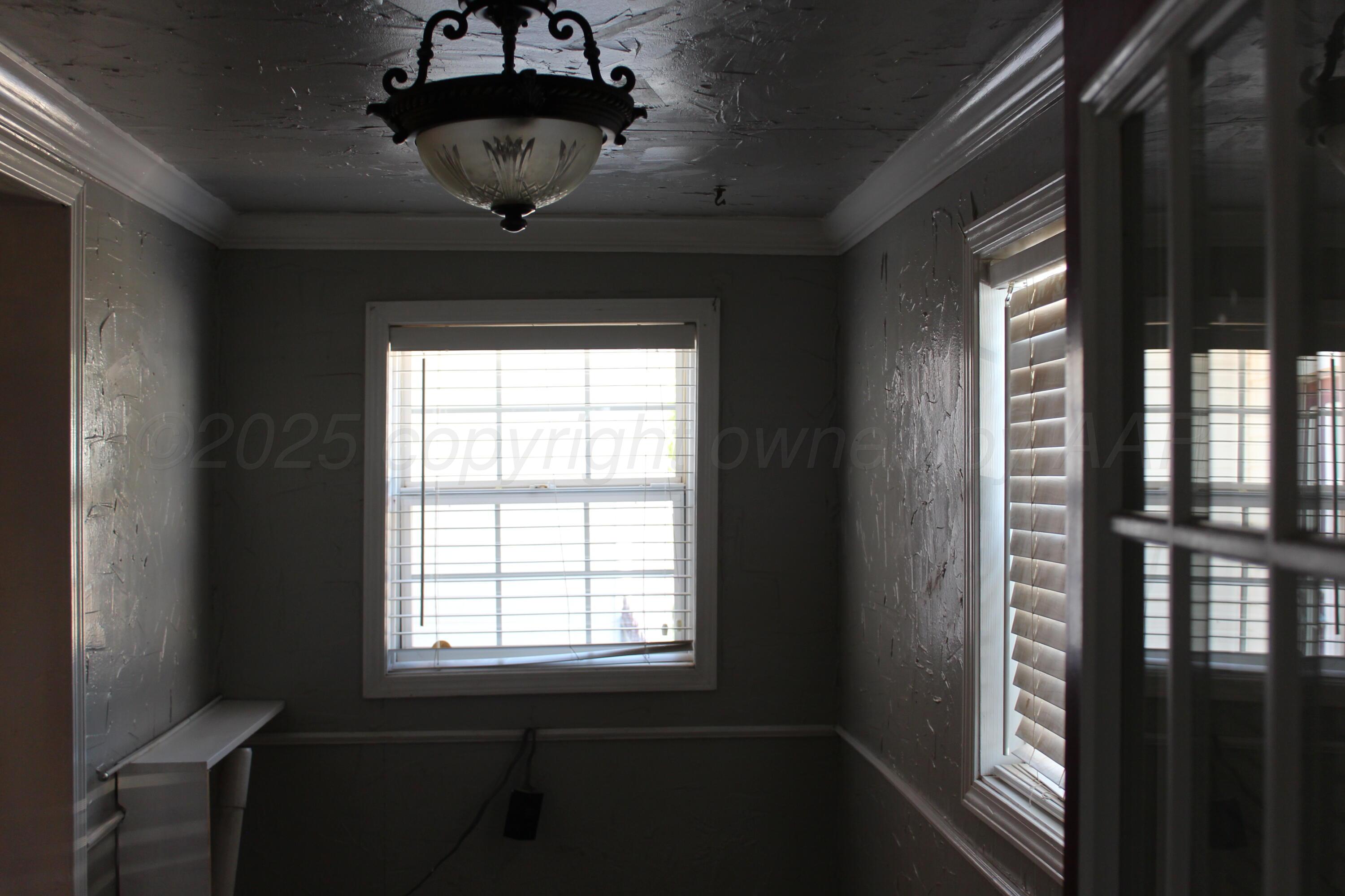 608 North 10th Street Memphis, TX 79245 - Photo 31 of 32 a picture of a room with a large window and wooden floor