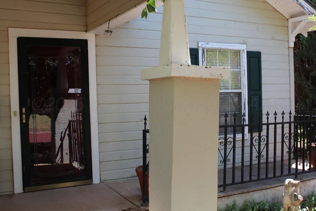a view of a house with a door and wooden door