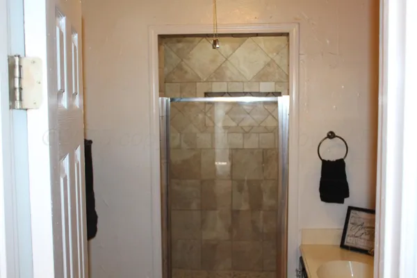 a bathroom with a glass shower door