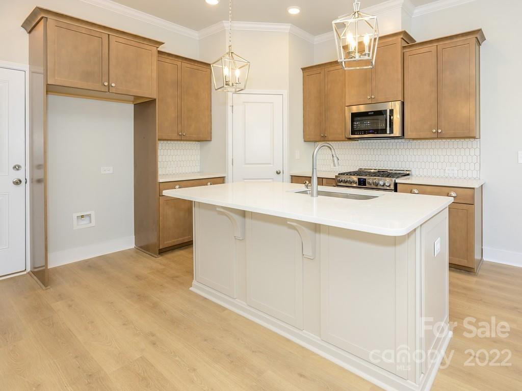 5915 Ardrey Kell Road Charlotte, NC 28105 - Photo 12 of 32 a kitchen with stainless steel appliances a sink stove and refrigerator