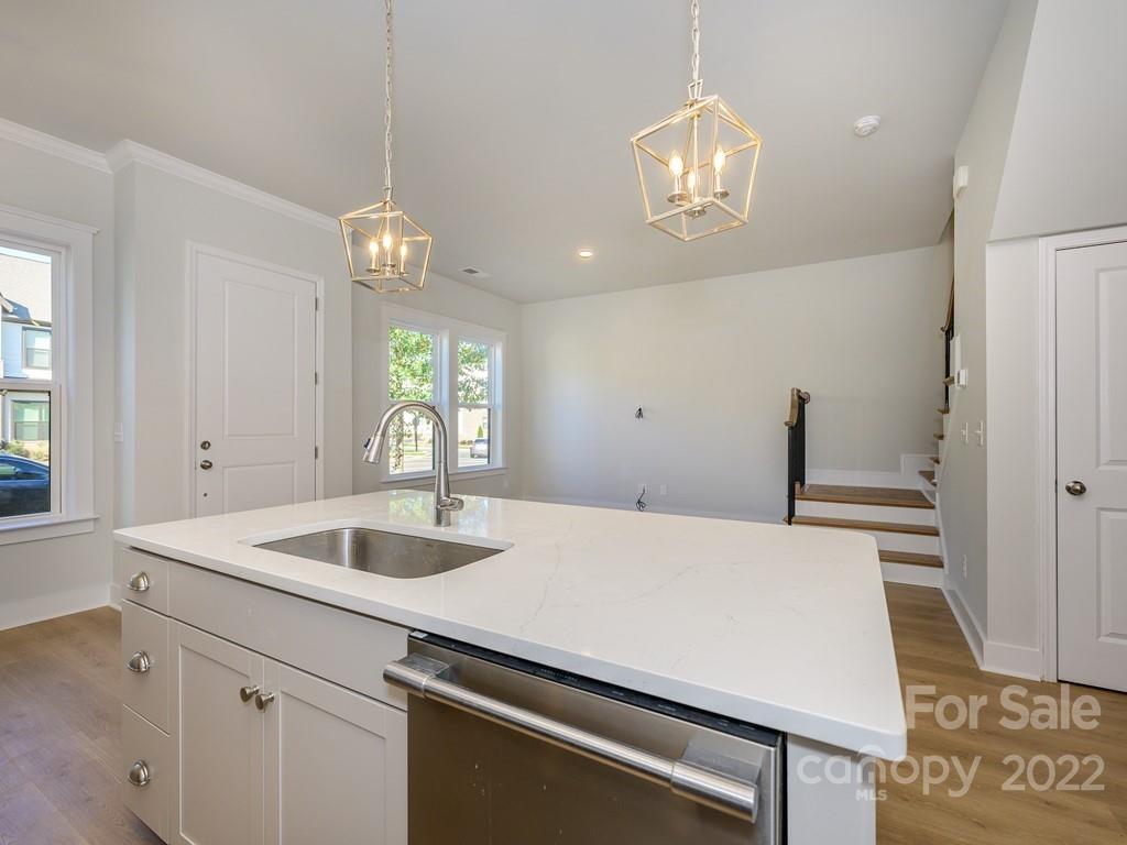 5915 Ardrey Kell Road Charlotte, NC 28105 - Photo 14 of 32 a kitchen with a sink and chandelier