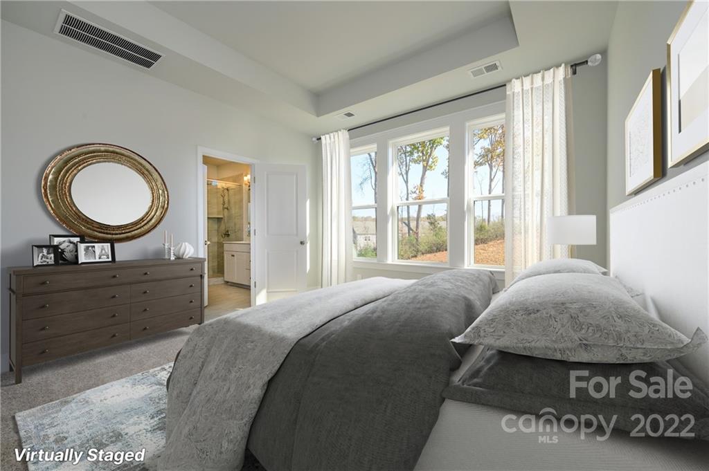 5915 Ardrey Kell Road Charlotte, NC 28105 - Photo 17 of 32 a bedroom with a bed a mirror and a window