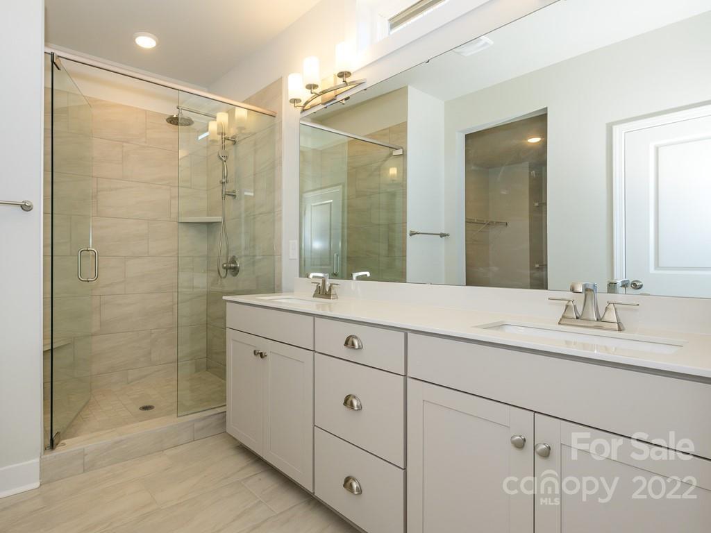 5915 Ardrey Kell Road Charlotte, NC 28105 - Photo 19 of 32 a bathroom with double sink shower and two mirror