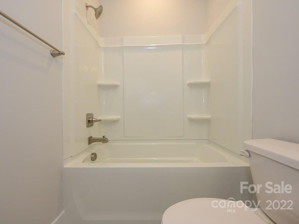 5915 Ardrey Kell Road Charlotte, NC 28105 - Photo 27 of 32 a bathroom with a toilet and a bathtub