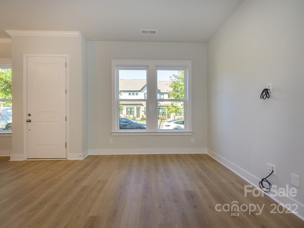 5915 Ardrey Kell Road Charlotte, NC 28105 - Photo 6 of 32 an empty room with wooden floor and windows