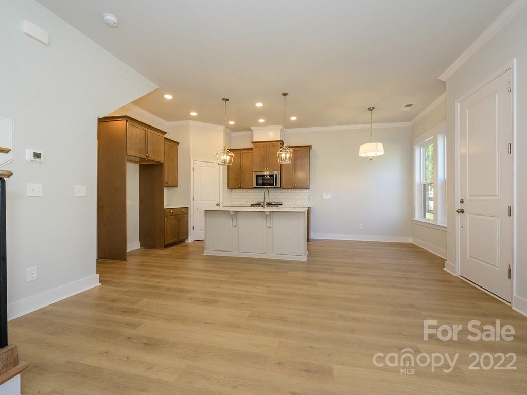 5915 Ardrey Kell Road Charlotte, NC 28105 - Photo 7 of 32 a view of a kitchen with a sink and a refrigerator